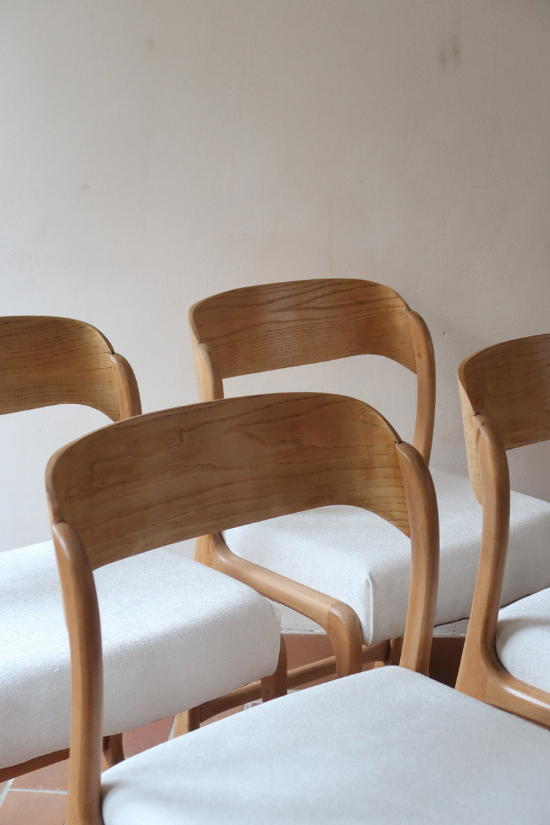 Lot de 4 chaises Baumann modèle Bémol en bois clair finition mate avec assises épaisses retapissées en bouclette écru.