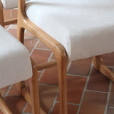 Lot de 4 chaises Baumann modèle Bémol en bois clair finition mate avec assises épaisses retapissées en bouclette écru.