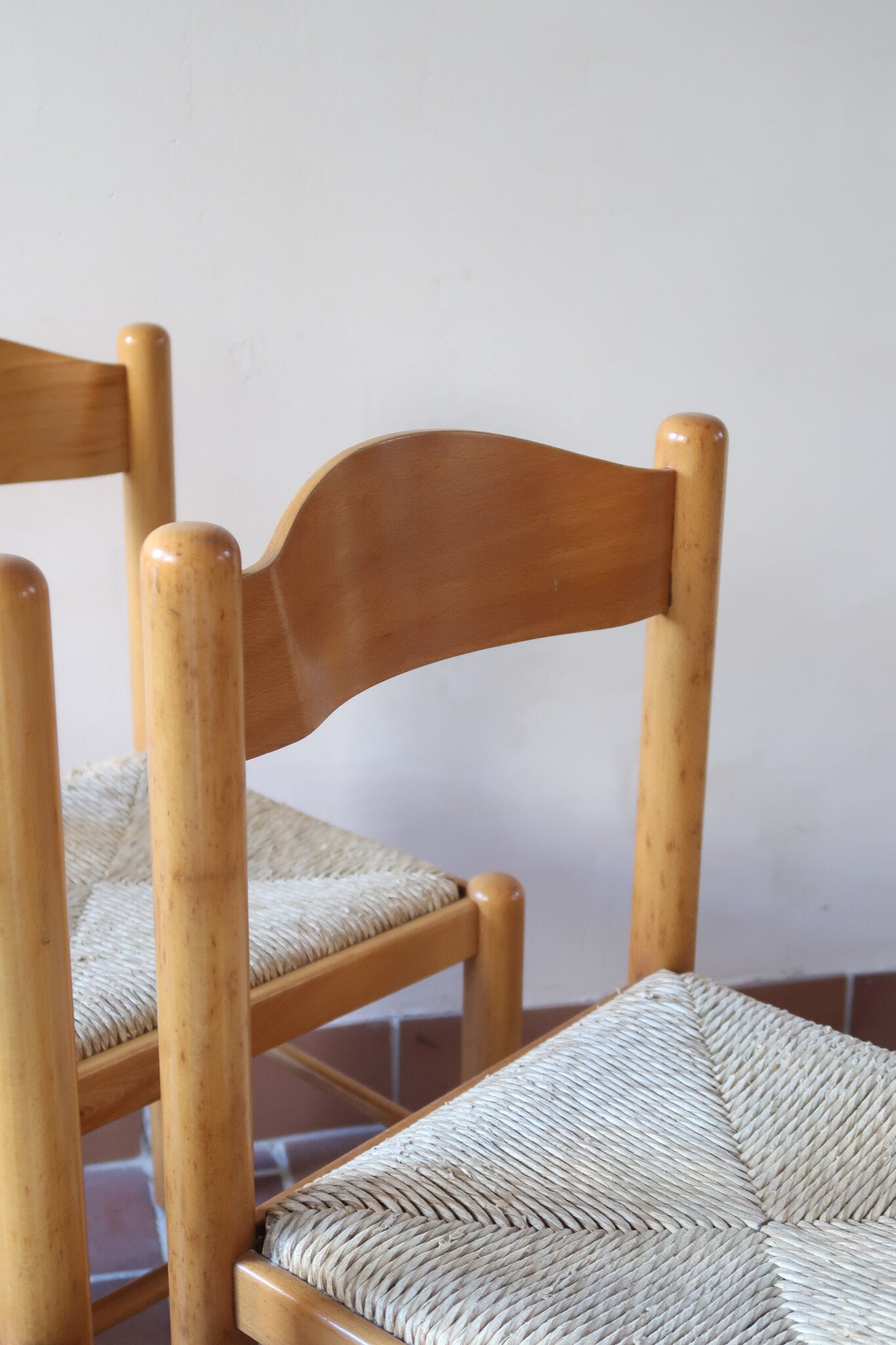 Chaises vintage en pin massif, lot de 4, assises paillées à la main tressées en épi, dossier à bandeau chantourné en arc, montants tournés à boule et pieds ronds réunis par des barreaux