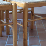 Chaises vintage en pin massif, lot de 4, assises paillées à la main tressées en épi, dossier à bandeau chantourné en arc, montants tournés à boule et pieds ronds réunis par des barreaux