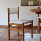 Lot de six chaises vintage des années 80 en pin massif avec assise et dossier en tissu bouclette blanc cassé, style Charlotte Perriand, présentées seules ou mises en situation dans différents espaces.