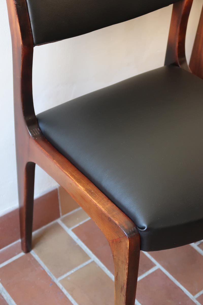 Lot de six chaises scandinaves vintage en teck massif avec assise et dossier en skaï noir, style Niels Otto Møller ou Erik Buch, présentées seules et en mise en situation dans différents espaces.