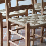 Série de 4 chaises rustiques en bois et assise paillée — années 60