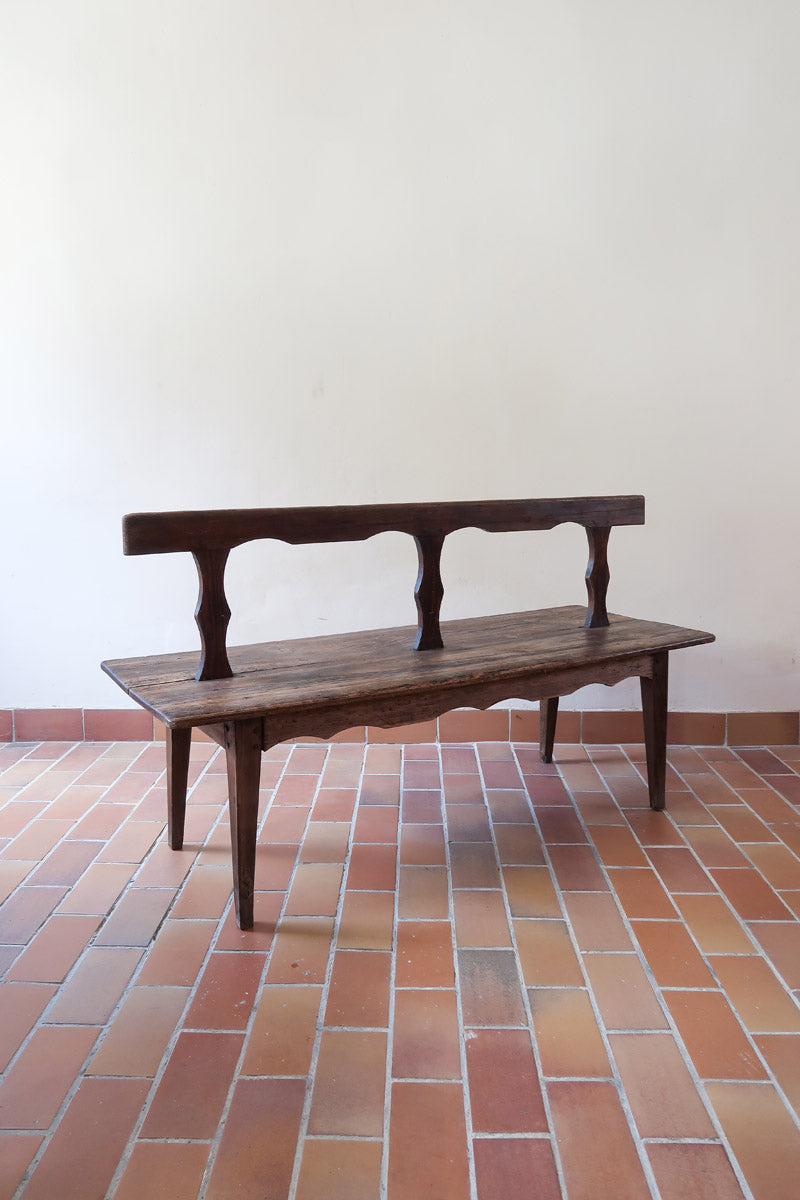 Banc rustique ancien bois massif chantourné, dossier ajouré montants festonnés, assise planche pleine patinée, mobilier vernaculaire français campagne