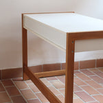 Bureau scandinave années 70 laqué blanc et bois clair, deux tiroirs à boutons ronds en bois, piétement à entretoise basse, lignes épurées mid-century