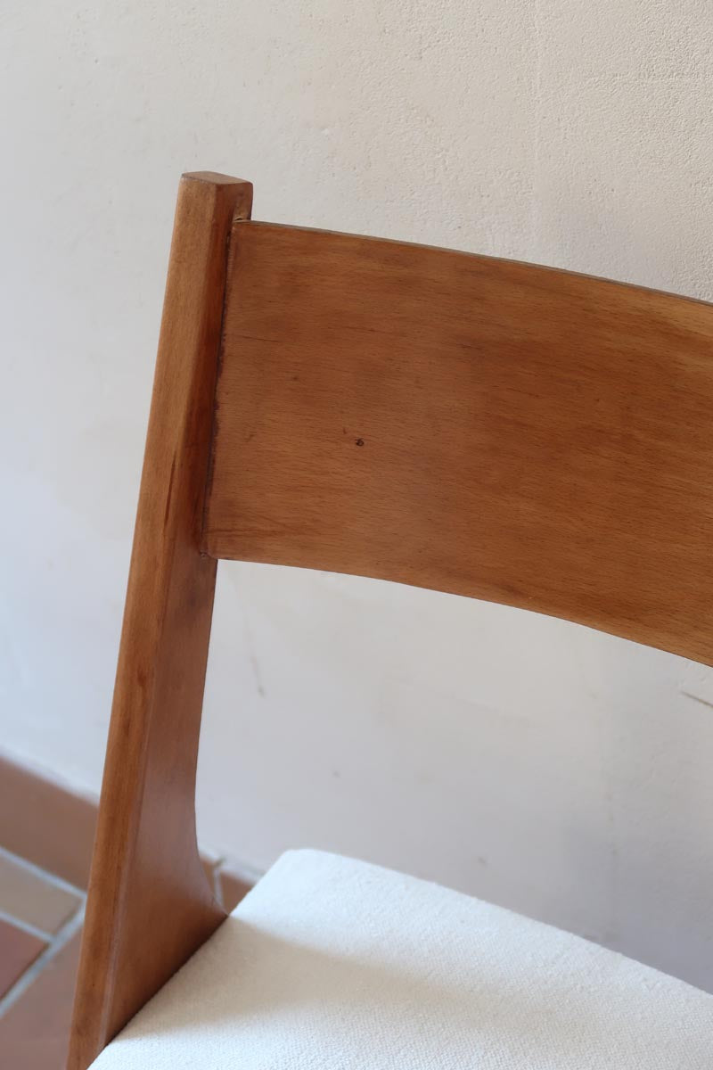 Deux chaises vintage en hêtre massif des années 50 avec assise en tissu bouclette clair, design épuré à la René-Jean Caillette, présentées seules et en mise en situation.