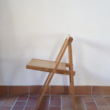 Quatre chaises pliantes en bois massif années 70 style Aldo Jacober avec dossier épais et assise à lattes.