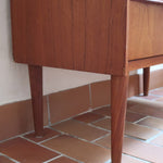 Commode danoise en teck des années 60 avec quatre tiroirs et lignes sobres typiques du mobilier scandinave mid-century.