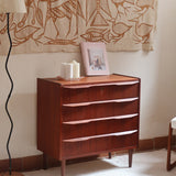 Commode scandinave en teck années 60 à quatre tiroirs et pieds compas, teinte chaude, design mid century.