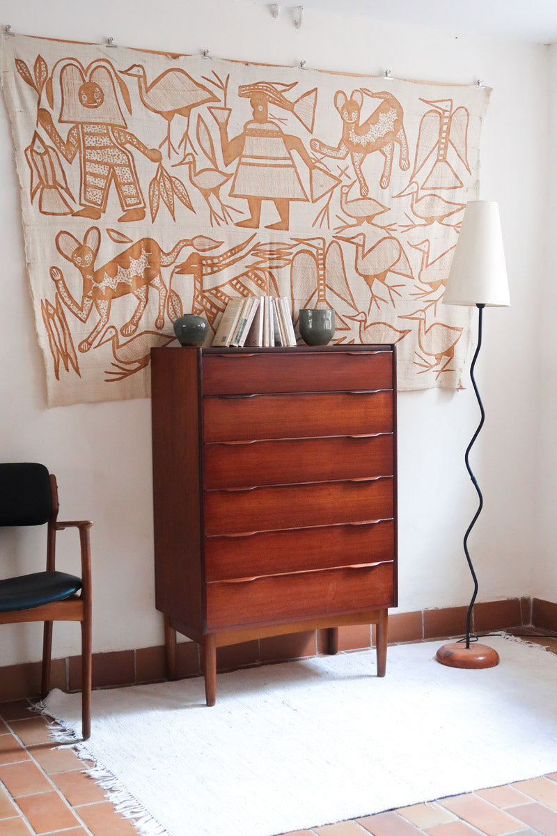Commode haute scandinave en teck années 60 à six tiroirs avec poignées intégrées et piètement fuselé.