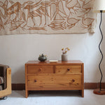 Commode basse en pin massif années 70 à trois tiroirs avec assemblages à queues d’aronde visibles et poignées rondes en bois.