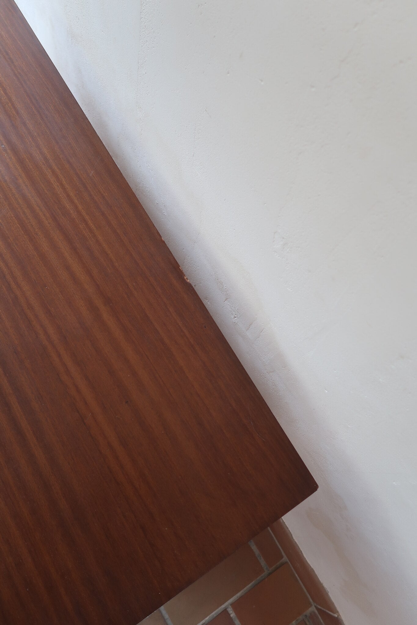 Commode vintage 3 tiroirs en teck années 60, façades pleines à prise de main creusée, piétement fin en métal laqué noir, style scandinave
