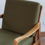 Fauteuil danois vintage en bois sculpté avec assise vert olive, design organique des années 60.