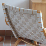 Fauteuil lounge en chêne avec assise et dossier en sangles tissées claires, design danois années 50
