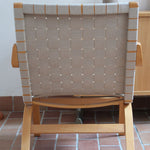 Fauteuil lounge en chêne avec assise et dossier en sangles tissées claires, design danois années 50