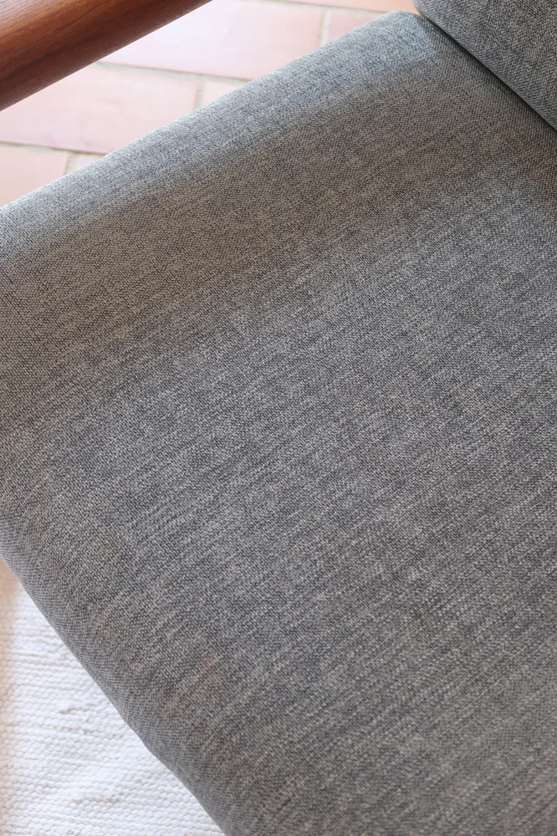 Fauteuil scandinave en teck Komfor avec coussins bleu gris déhoussables et piètement luge, fabriqué au Danemark.