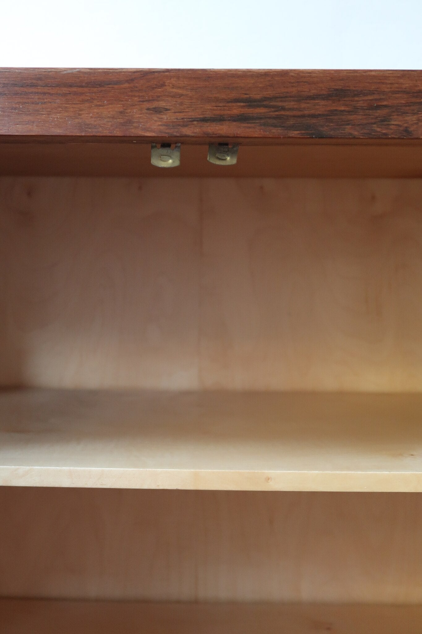 Grande enfilade vintage en palissandre de 240 cm, placage au fil en miroir, deux caissons fermant à clé de part et d'autre d'une niche centrale ouverte, tablettes intérieures en bois clair, reposant sur deux pieds pleins posés en retrait