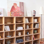 Meuble à casiers vintage en bois clair, style atelier industriel, avec 20 compartiments ouverts pour rangement de livres, vinyles ou objets décoratifs, présenté seul et en mise en situation.