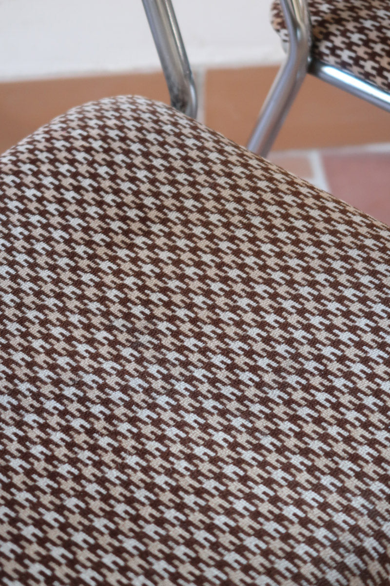 Paire de chaises vintage en chrome tubulaire avec assise et dossier en tissu à motif géométrique.
