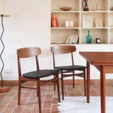  Paire de chaises scandinaves en teck avec assise en skaï noir, design danois des années 60 inspiré de Niels O. Møller.