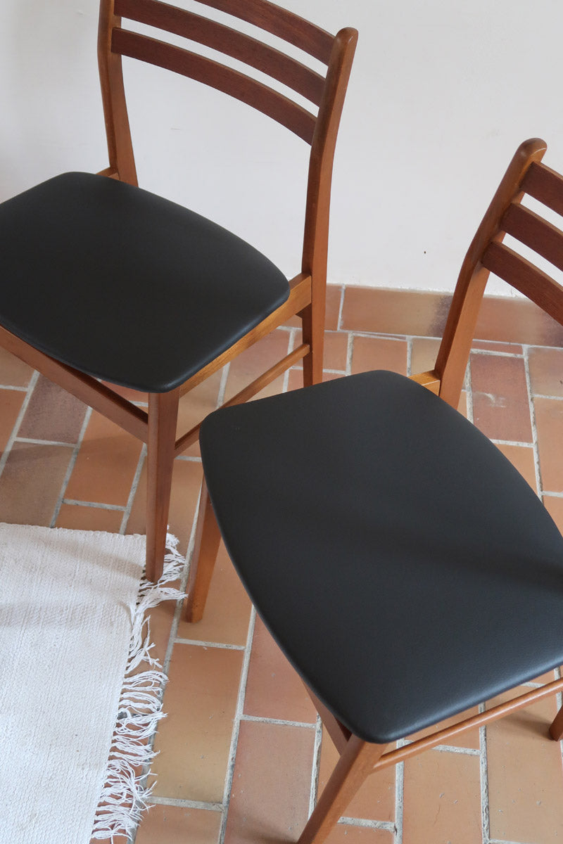 Paire de chaises scandinaves en teck avec dossier à lattes et assise en skaï noir, design danois des années 60.