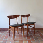 Paire de chaises scandinaves Farstrup vintage en teck et skaï noir neuf