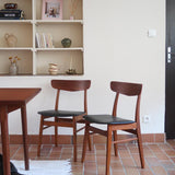 Paire de chaises scandinaves vintage Farstrup en teck et skaï noir