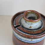 Pot couvert grès artisanal années 70, cylindrique, couvercle coupelle intégrée, bandes émail brun rouille blanc cassé moucheté liseré bleu cobalt