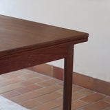 table à manger scandinave en teck massif extensible années 60 avec rallonges intégrées et piètement fuselé