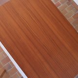 table à manger scandinave en teck massif extensible années 60 avec rallonges intégrées et piètement massif