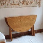 Table Ercol drop leaf en bois massif clair, plateau ovale à abattants, années 70.
