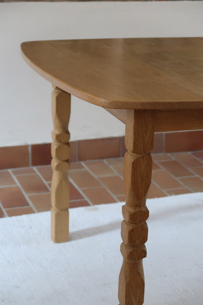 Table extensible Henning Kjærnulf en chêne massif avec pieds sculptés et deux rallonges intégrées, design danois années 60.