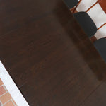 Table à manger Skovby en teck foncé avec plateau noir, piétement traîneau et deux rallonges, design danois des années 70.