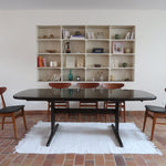 Table à manger Skovby en teck foncé avec plateau noir, piétement traîneau et deux rallonges, design danois des années 70.