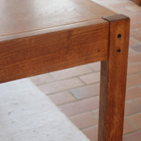 Table à manger extensible en bois massif années 60 avec deux rallonges intégrées sous le plateau.