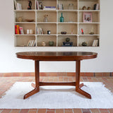 Table à manger ovale en teck avec deux rallonges intégrées, design scandinave des années 60, piètement central en bois.