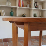 Table ronde extensible en orme massif attribuée à Maison Regain, années 80, plateau à motifs géométriques, rallonge intégrée, patine naturelle.