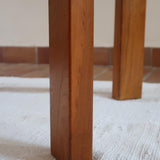 Table ronde extensible en orme massif attribuée à Maison Regain, années 80, plateau à motifs géométriques, rallonge intégrée, patine naturelle.