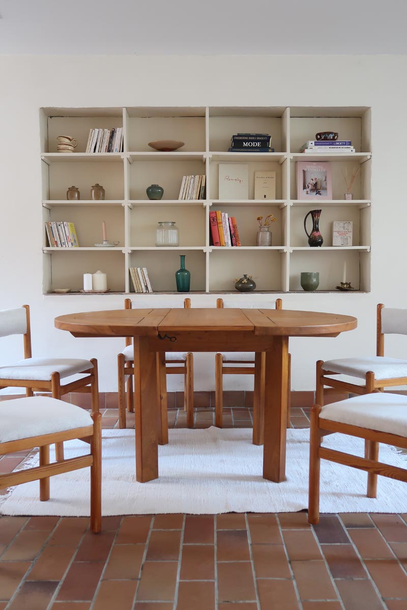 Table ronde extensible en orme massif attribuée à Maison Regain, années 80, plateau à motifs géométriques, rallonge intégrée, patine naturelle.