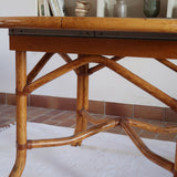 Table à manger ovale extensible bois clair piètement rotin années 70, rallonge centrale, ligatures cuir, jusqu'à 8 couverts