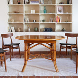 Table à manger ovale extensible bois clair piètement rotin années 70, rallonge centrale, ligatures cuir, jusqu'à 8 couverts
