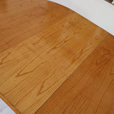 Table à manger ovale extensible bois clair piètement rotin années 70, rallonge centrale, ligatures cuir, jusqu'à 8 couverts