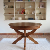 Table ronde vintage à rallonge en chêne massif éditée par Lübke, Allemagne années 60, estampille d'origine sous le plateau, piétement central à quatre jambes plates croisées en X réunies par un moyeu rond, allonge centrale