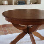 Table ronde vintage à rallonge en chêne massif éditée par Lübke, Allemagne années 60, estampille d'origine sous le plateau, piétement central à quatre jambes plates croisées en X réunies par un moyeu rond, allonge centrale