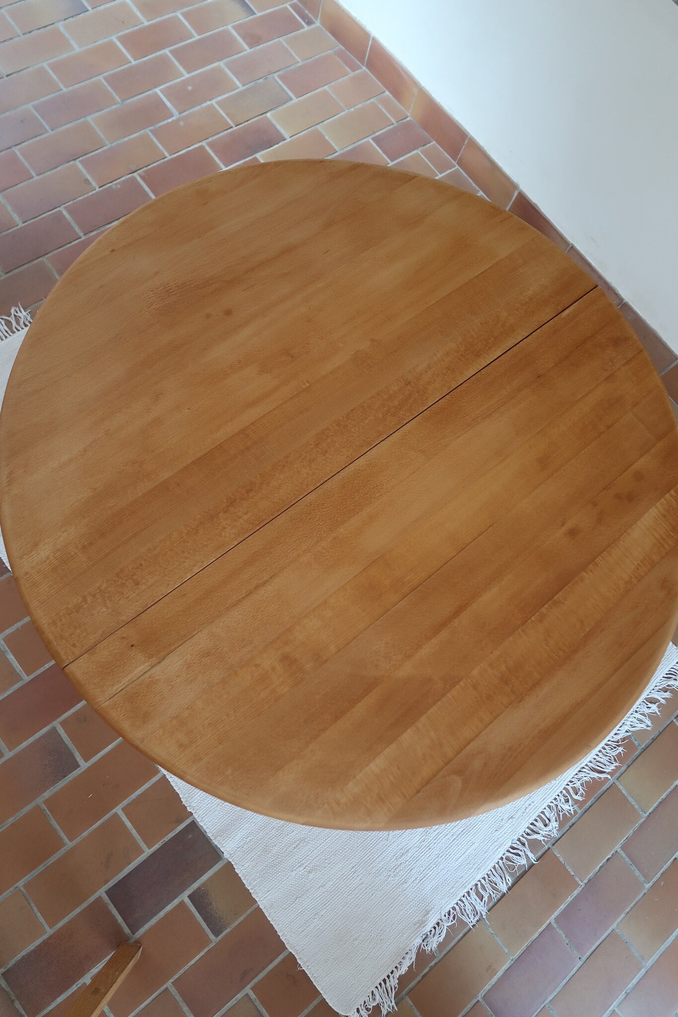 Table ronde extensible vintage en bois de hêtre massif, années 80, formée de deux demi-lunes assemblées par des taquets de bois pivotants, deux rallonges centrales, passant de 121 à 181 cm, démontable