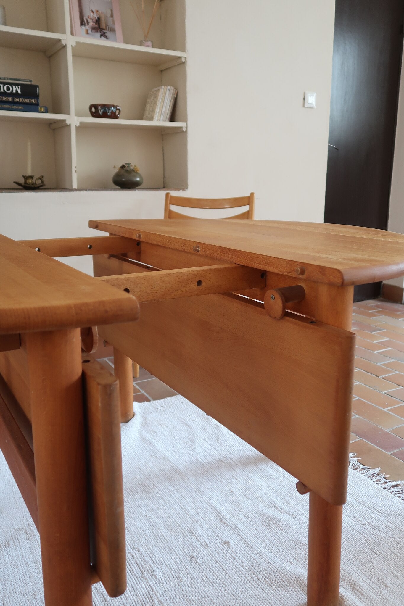 Table ronde extensible vintage en bois de hêtre massif, années 80, formée de deux demi-lunes assemblées par des taquets de bois pivotants, deux rallonges centrales, passant de 121 à 181 cm, démontable