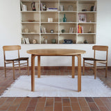 Table ronde extensible chêne Thygesen Sørensen Magnus Olesen années 70, pieds courbés sculptés, 2 rallonges