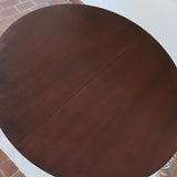 Table ronde extensible Farstrup en palissandre années 70, pied central étoile, fabrication danoise, jusqu'à 10 couverts avec rallonge