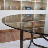 Table à manger ronde vintage années 70, piétement rotin et bambou cintré teinté foncé, ligatures rotin, plateau verre fumé