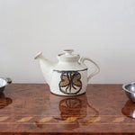 Théière grès émaillé artisanal années 70, décor peint main trèfle quatre feuilles, blanc cassé moucheté brun doré, liseré noir col, tournée main